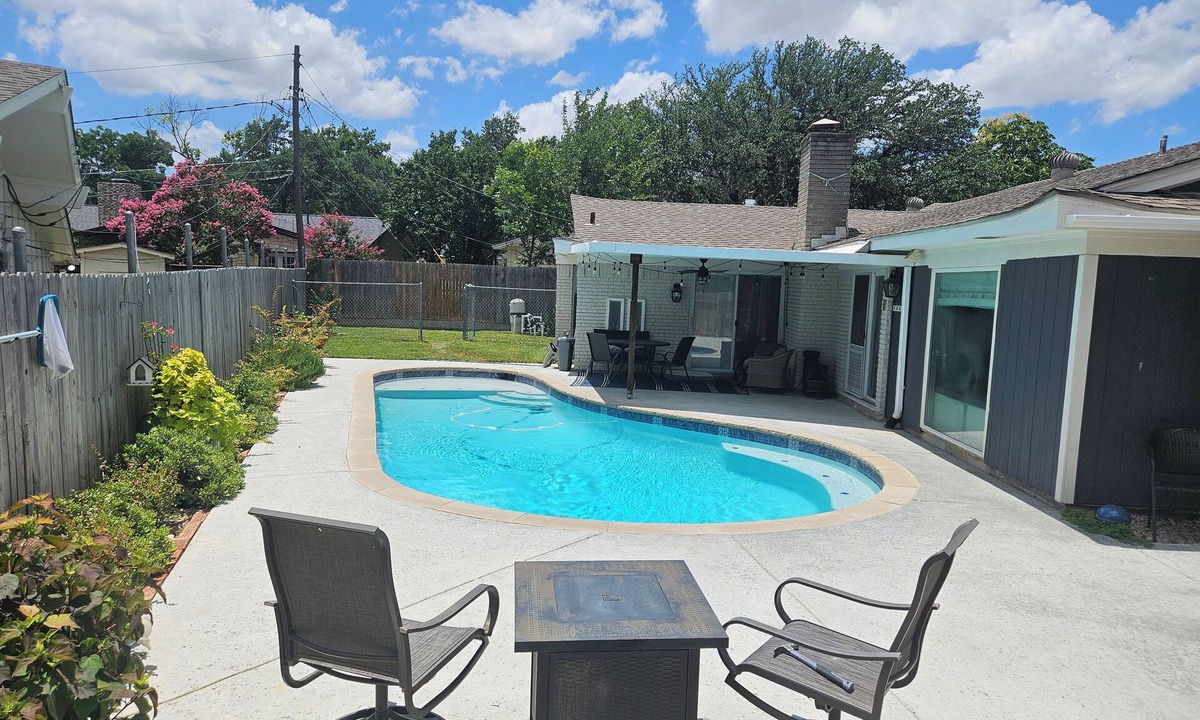 Haltom City House | Central DFW location with cozy fireplace and pool.