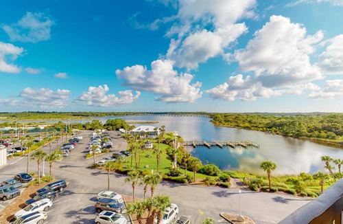 Sunnyside House | Beachfront condo in gated resort with pools lake access fast WiFi & patio