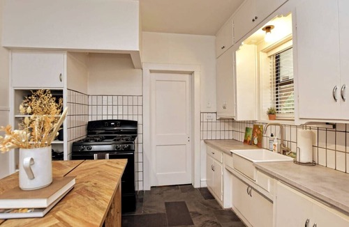 Austin Ave. Villa | Cozy Tudor Bungalow in Waco