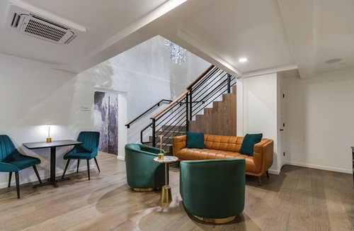 San Angelo Hotel | Elegant Suite with Separate Living Room & Mini Fridge – Ideal for Relaxation and