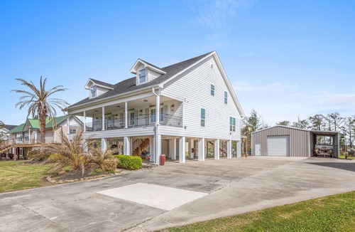 Moss Bluff House | Luxury riverfront home w/pool, fishing dock, & boat house w/lift ! Sleeps 14
