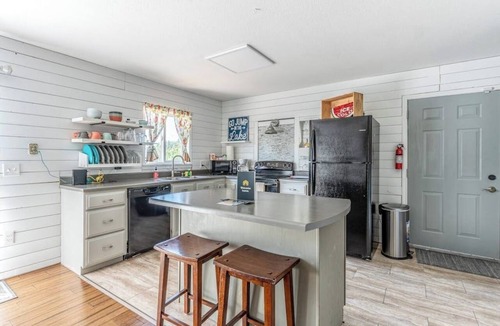 Woods Bay House | Mountain-view home with large deck, gas grill, firepit, lawn, and central AC