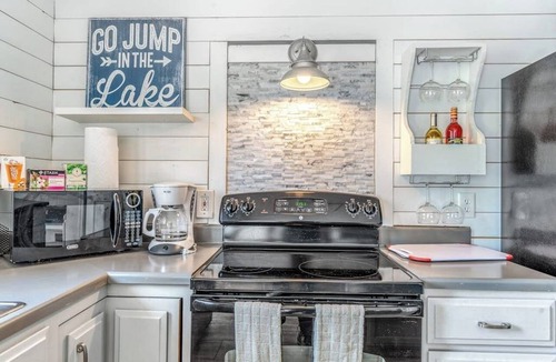 Woods Bay House | Mountain-view home with large deck, gas grill, firepit, lawn, and central AC