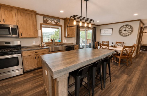 Marvel House | Riverfront Home with Hot Tub, AC, Large Deck