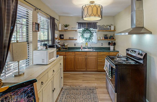 Bandera Cottage | Riverside Retreat with outside dining area, deck and internet
