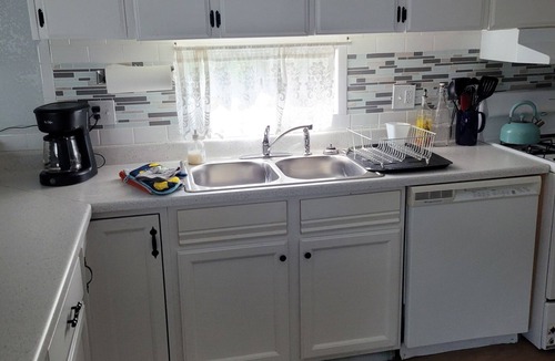 Longmont House | Spacious mobile home with large kitchen/living area and porch with barbeque.
