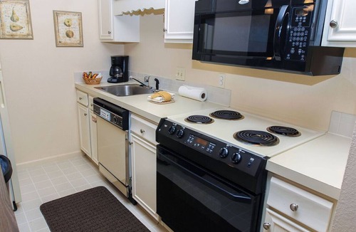 Estes Park Condo | Suite features King bed, full kitchen, and deck with a river view.
