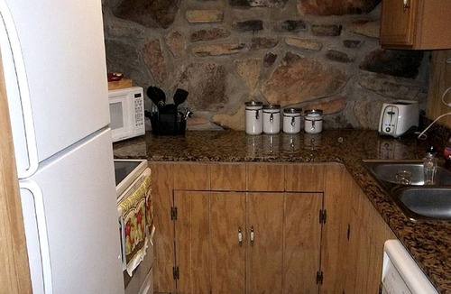 Omaha Cottage | Tranquil Stone Cottage Behind Castle Walls in the Ozarks