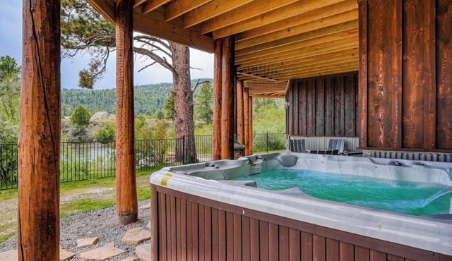 Custom riverfront log home w/hot tub, decks & fireplace