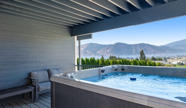 Lake & mountain view home with hot tub, pool, 2 decks, game room, & fireplace
