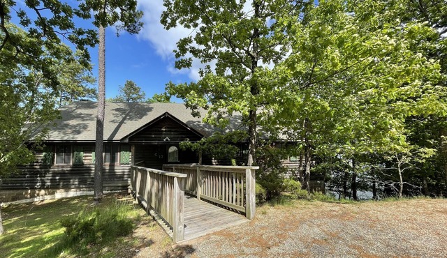 Lake view three bedroom, three bath log-sided cottage with private hot tub overlooking Lake Ouachita. by RedAwning